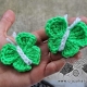 two crochet butterflies on the palm