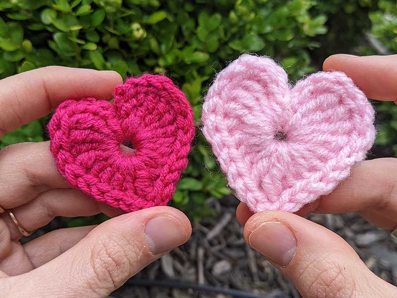 two crochet hearts held next to each other