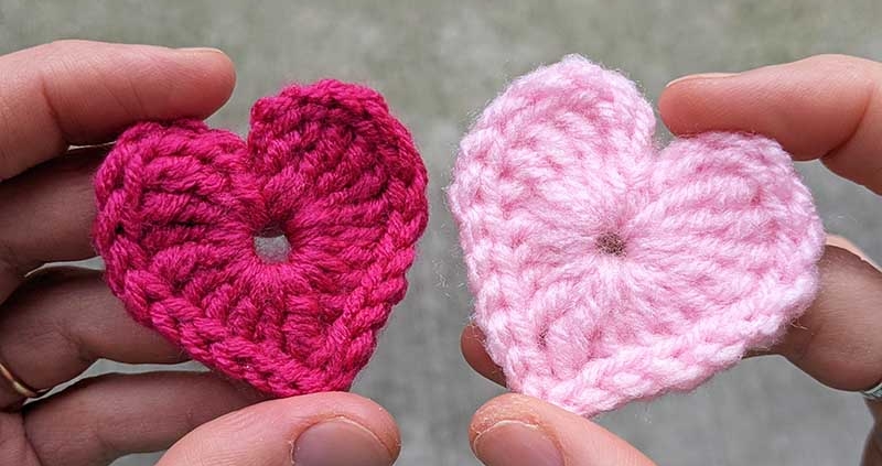 two tiny crochet hearts - one red and one pink coloured
