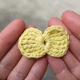 crochet tiny bow made with yellow yarn