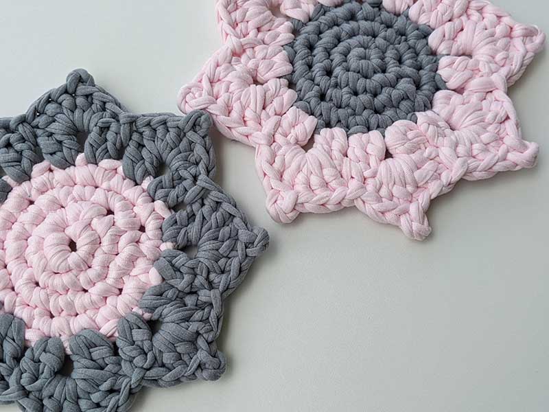 two crochet bi-colored sunflower hot pads