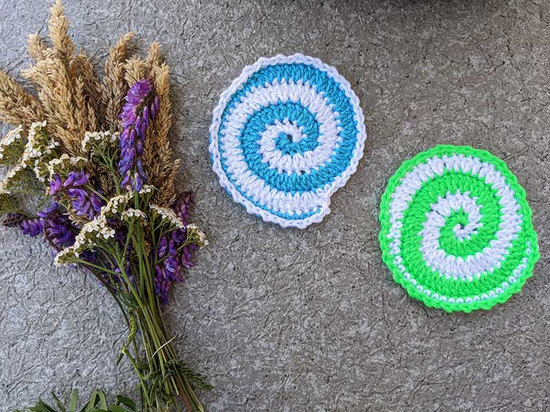 two crochet bi-colored spiral hot pads - blue & white yarn and green & white yarn