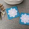 two crochet granny squares with Christmas-style snowflake