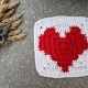 crochet granny square with red heart and white canvas