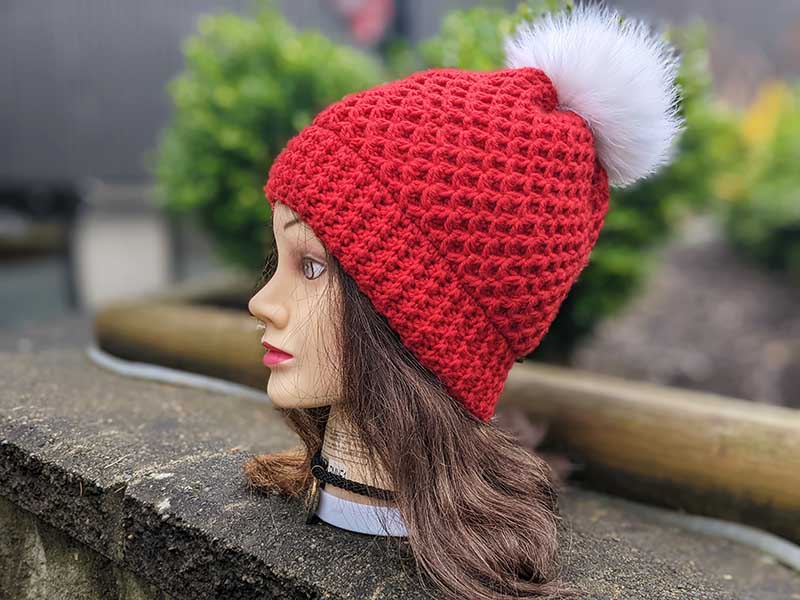 crochet diamond hat with fur pom - left side view