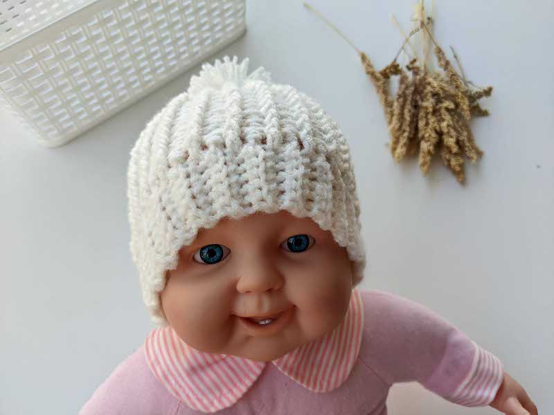 newborn baby crochet hat on a baby doll mannequin