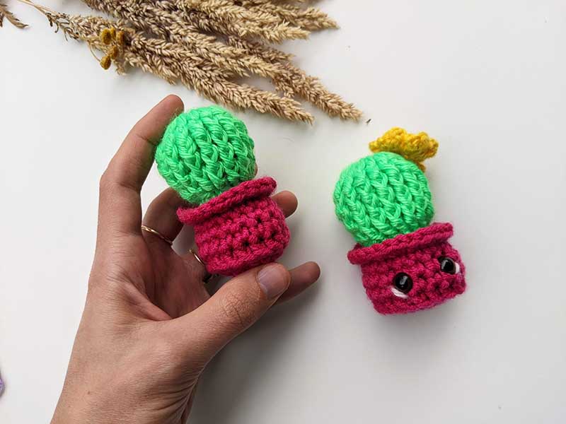 two crochet cactus amigurumi - green cactus with yellow flower and red flower pot