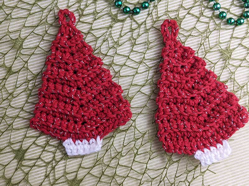 two crochet mini Christmas trees with a loop at the top that can be joined together to form a garland