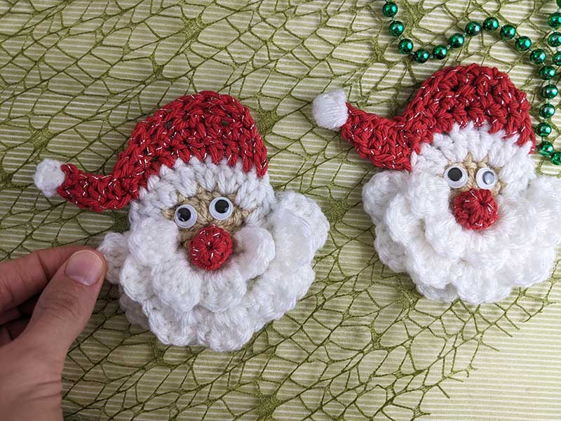 two crochet mini Santa heads