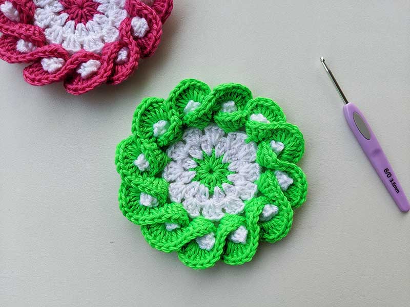 crochet flower coaster made with green yarn