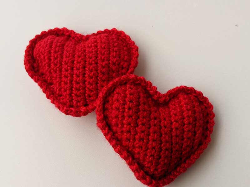 two crochet stuffed hearts