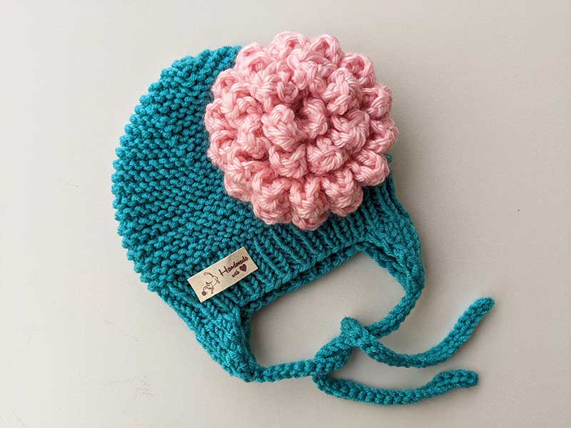 baby hat decorated with chunky crochet peony flower (attached to the side)