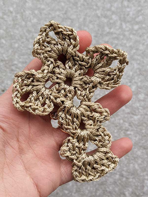 simple crochet cross made with golden yarn