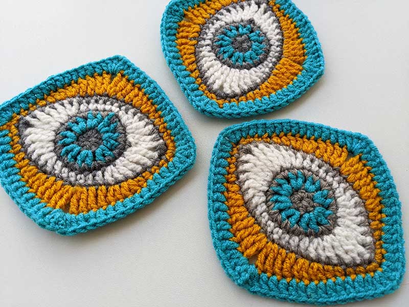 three crochet eye granny squares