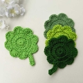 crochet clover leaf coasters made in different shades of green color