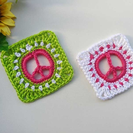 two crochet piece sign granny squares - one with green accent color, and another one with white accent color