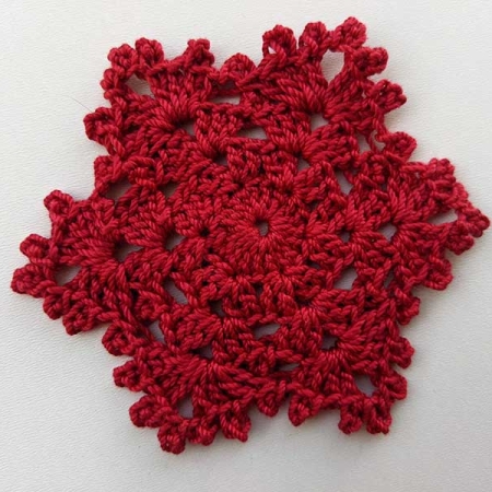 crochet simple snowflake made with red color yarn
