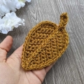 brown yarn crochet autumn leaf with a petiole and a midrib