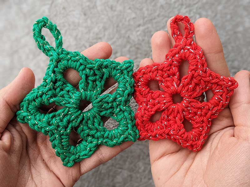 two crochet ornament stars made in green and red colors