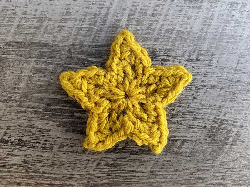 crochet five-point star made with yellow yarn
