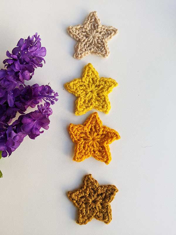 four crochet five-point stars arranged in a vertical line