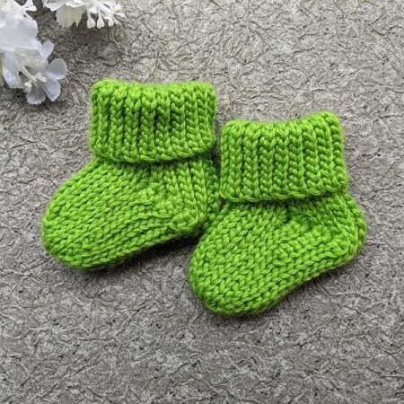 a pair of crochet socks for a newborn baby
