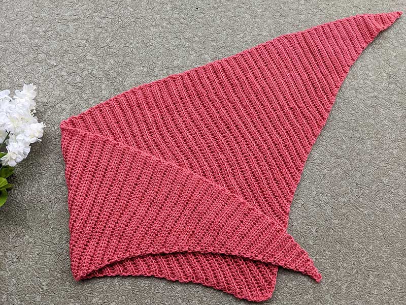 crochet triangular shawl with one of the corners folded