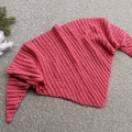 crochet triangular wrinkled shawl on a flat surface