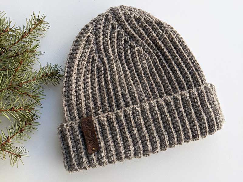 flat crochet men's ribbed hat on a flat surface