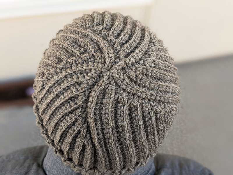 flat crochet ribbed hat on a male model - top view of the hat's crown