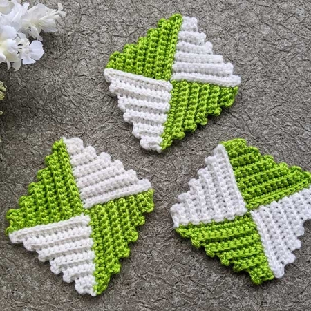 three crochet textured granny squares made in green and white yarn from triangularly shaped sections