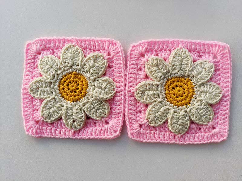 two crochet 3d daisy granny squared laying next to each other