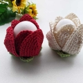 two crochet Easter tulip egg holders, one is red and another one is white