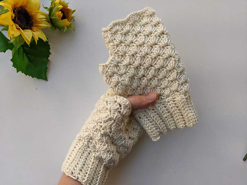 crochet fingerless gloves held in hands