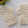 a pair of crochet white fingerless gloves