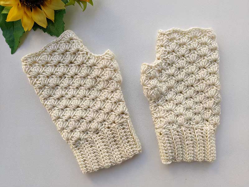 a pair of crochet white fingerless gloves