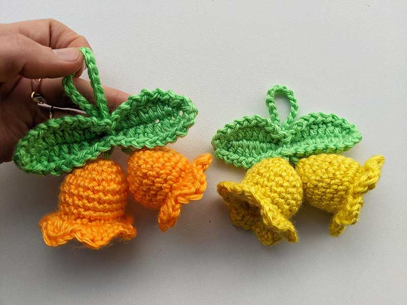a pair of crochet flower bells