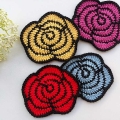 four crochet two-color roses arranged in two rows - pink, yellow, blue, and red