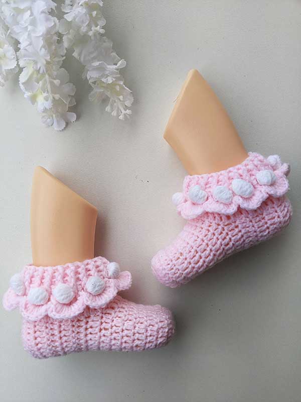 crochet baby ruffle socks on the mannequin's feet