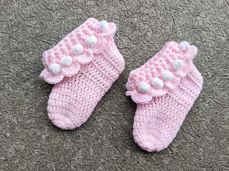 crochet baby ruffle socks on the flat surface