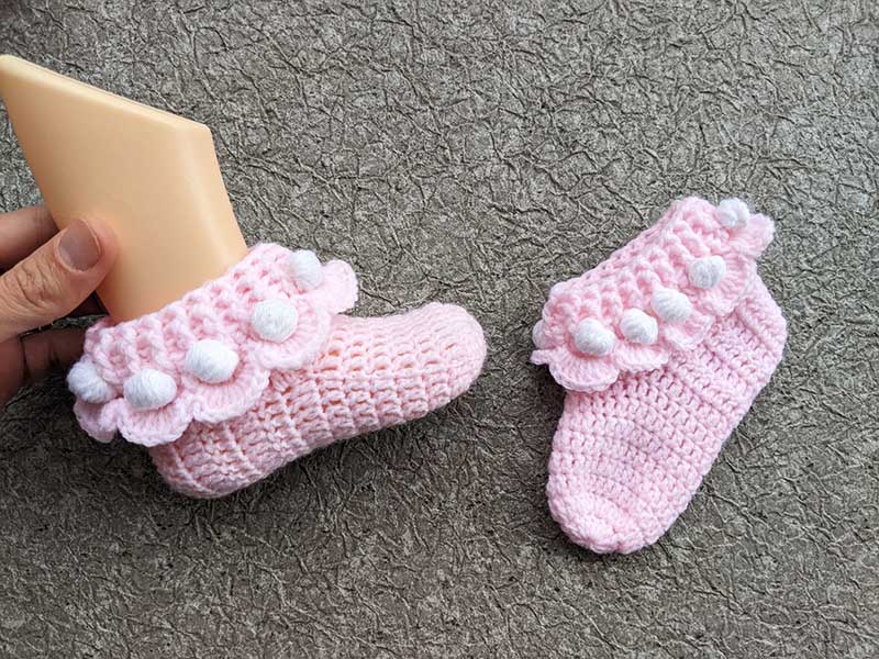 crochet ruffle socks on baby's mannequin feet