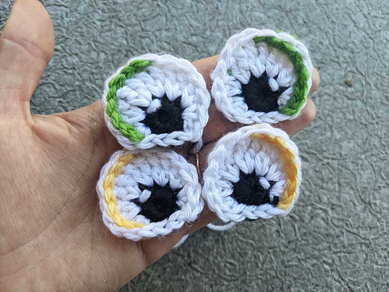 four crochet semi-oval eyes on a palm