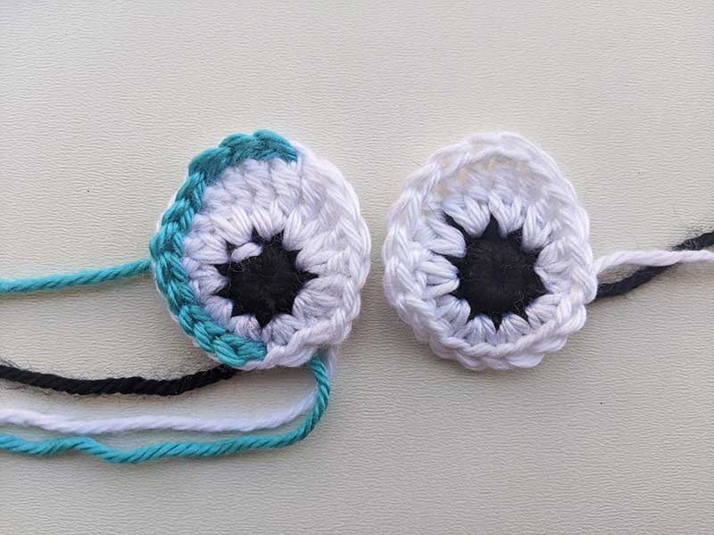 a pair of crochet oval eyes with loose ends