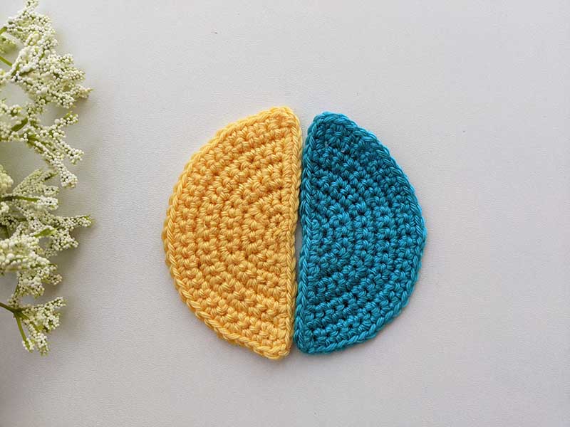 two crochet semi-circles - one blue and one yellow