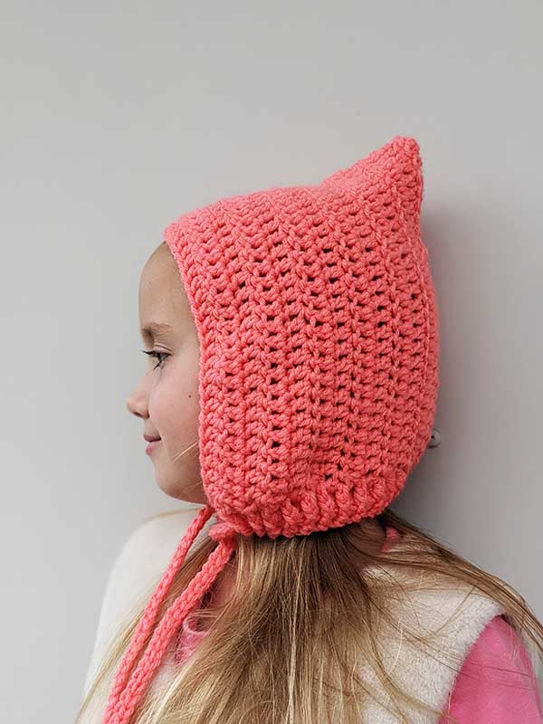 crochet pixie hat on a girl model - side view