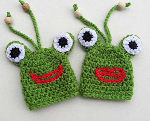 two crochet frog key covers