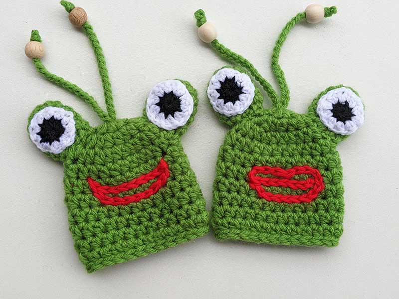 two crochet frog key covers