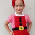 crochet Christmas headband and apron set on a kid model - close-up view