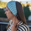 crochet headband with button closure on a female model