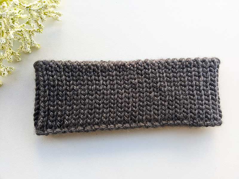 crochet one row ear warmer on a flat surface